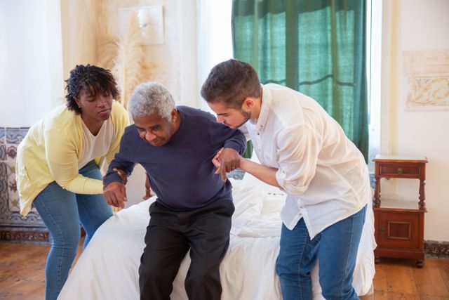 Caregivers assisting an older man with mobility and in-home care support in Cincinnati, OH